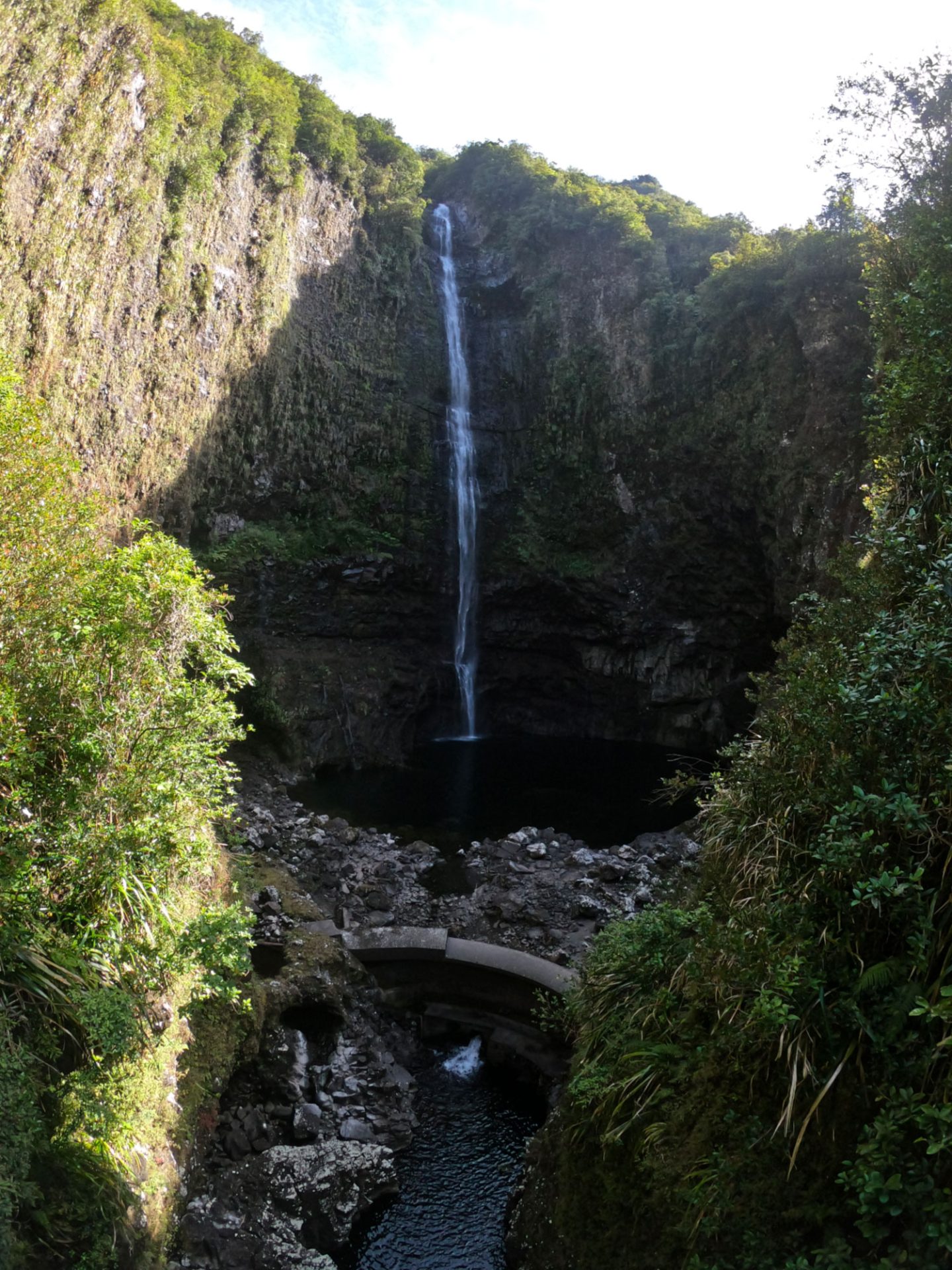 View of a waterfall from the hiking trail in the Takamaka Valley in Saint-Benoît
