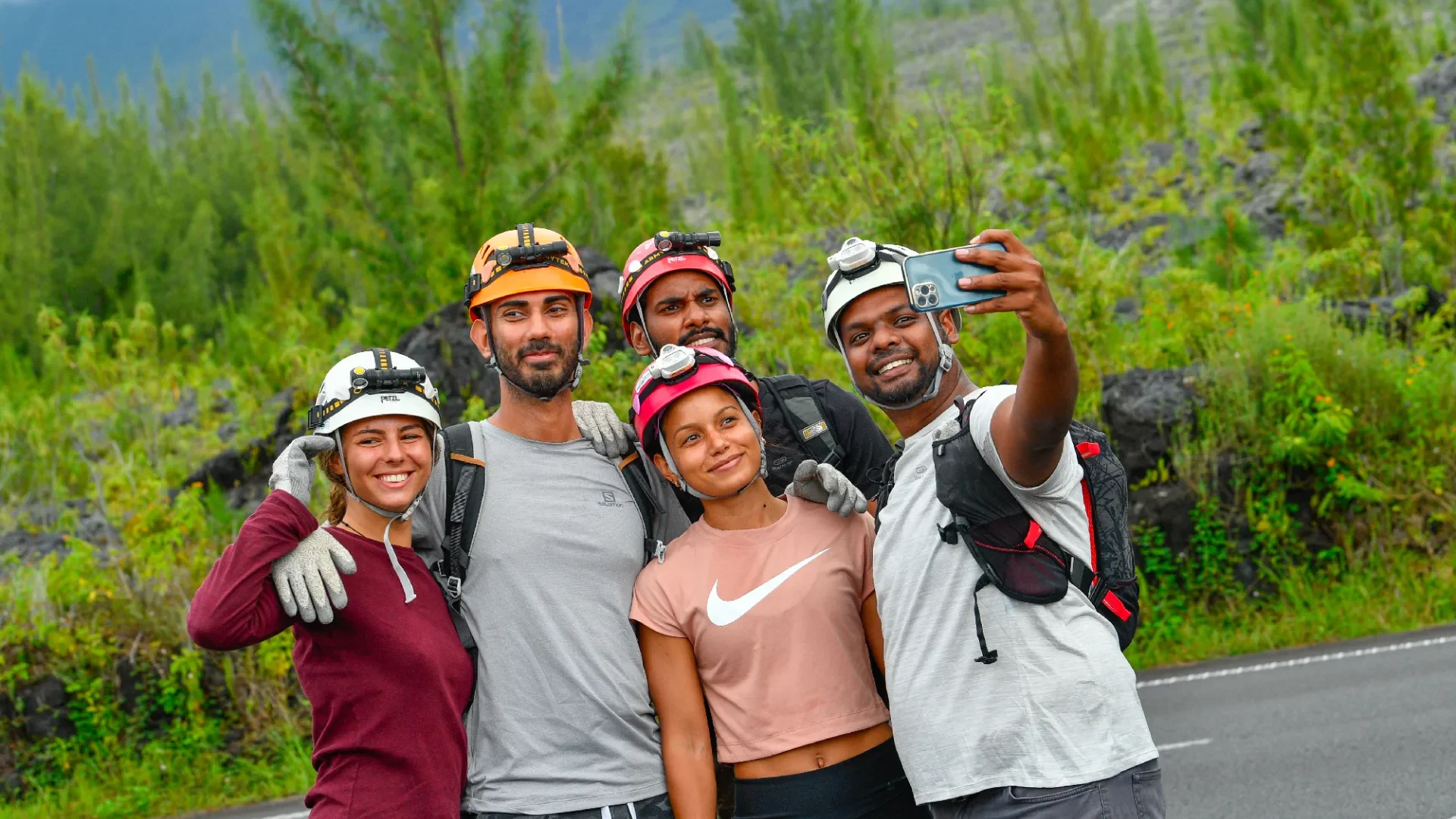 Holidays in the East of Reunion. Group of people taking selfies on the lava road in Sainte-Rose.