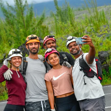 Holidays in the East of Reunion. Group of people taking selfies on the lava road in Sainte-Rose.