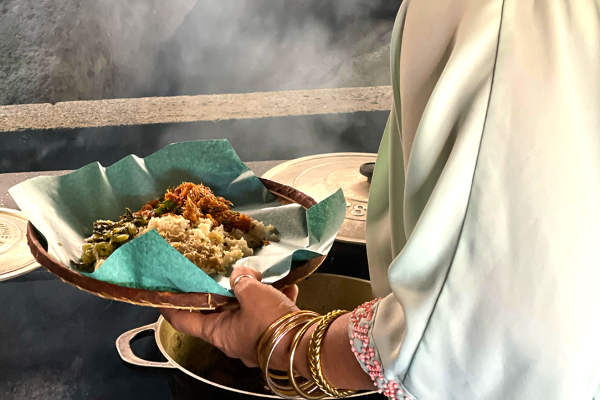 Reunionese cuisine woman serving carry in a banana leaf